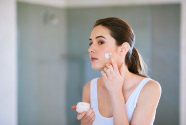 Crema hidratante aplicada en piel irritada por frío y viento en zona costera.